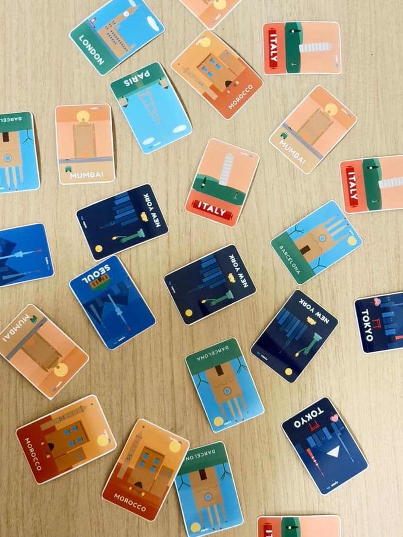 City-themed RyokoLife cards scattered on a table